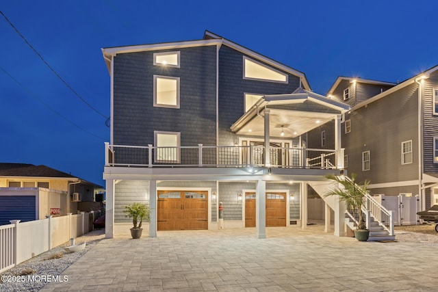 107 Bay Shore Dr, Toms River, NJ 08753 - view of front facade featuring fence, a garage, decorative driveway, and a balcony