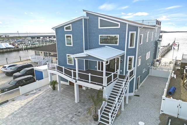 107 Bay Shore Dr, Toms River, NJ 08753 - rear view of house with stairway, a water view, and fence