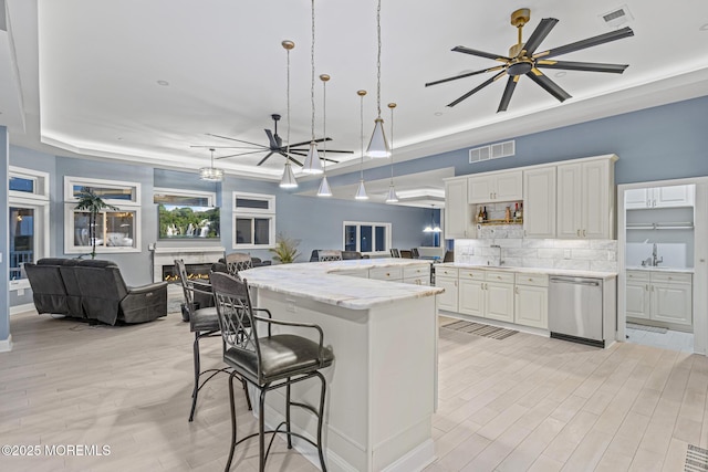 107 Bay Shore Dr, Toms River, NJ 08753 - kitchen with a breakfast bar, a sink, open floor plan, stainless steel dishwasher, and visible vents