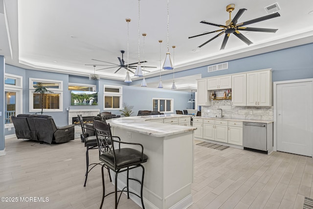 107 Bay Shore Dr, Toms River, NJ 08753 - kitchen featuring visible vents, a breakfast bar, open floor plan, a sink, and dishwasher
