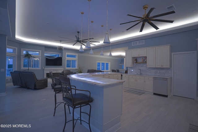 107 Bay Shore Dr, Toms River, NJ 08753 - kitchen featuring a sink, dishwasher, a kitchen bar, and visible vents