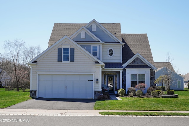 craftsman-style home with an attached garage, a front lawn, driveway, and roof with shingles