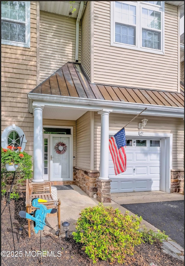 127 Windward Dr, Stafford, NJ 08050 - property entrance featuring a standing seam roof, metal roof, and stone siding