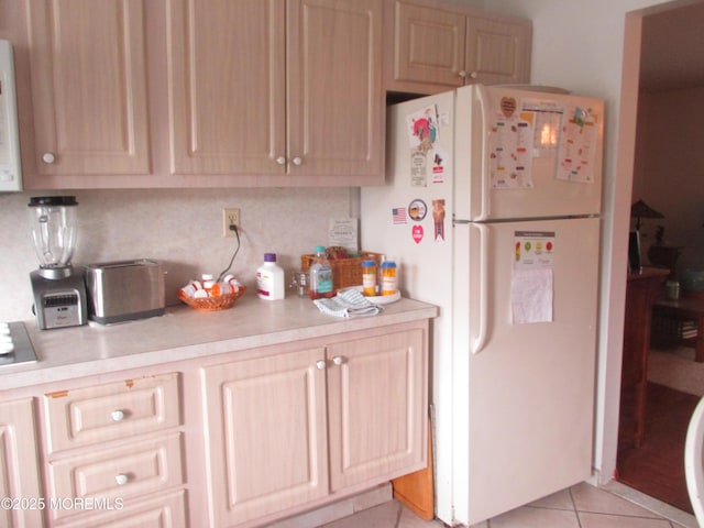 243D Jefferson Ct, Lakewood, NJ 08701 - kitchen with decorative backsplash, light brown cabinetry, light tile patterned floors, light countertops, and freestanding refrigerator
