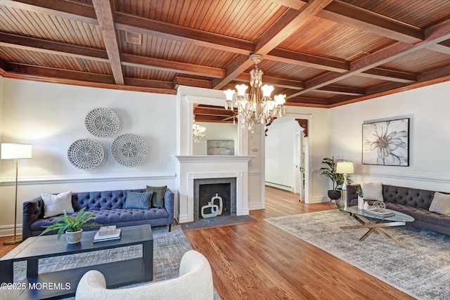 living room with beamed ceiling, wooden ceiling, an inviting chandelier, and a baseboard radiator