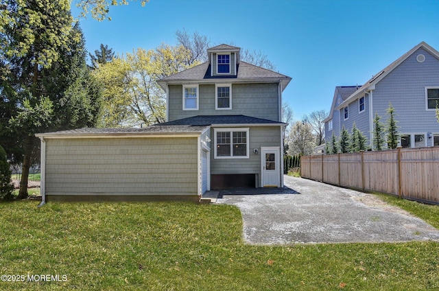 rear view of property with a patio area, fence, and a yard