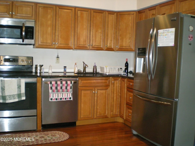 24 Dartmouth St Unit 61, Whiting, NJ 08759 - kitchen featuring brown cabinets, appliances with stainless steel finishes, a sink, and dark countertops