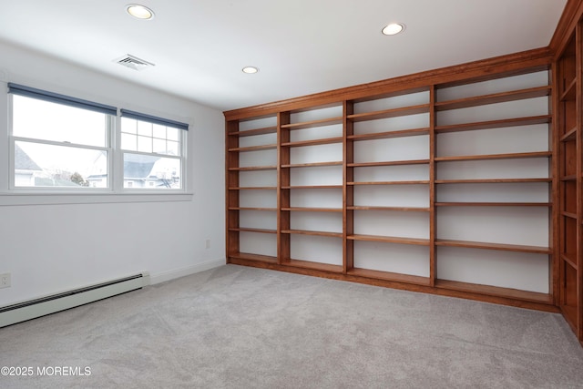 empty room featuring recessed lighting, light carpet, baseboard heating, and baseboards