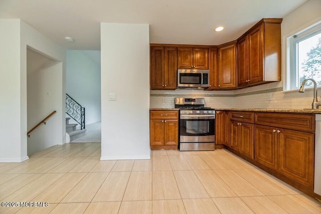 20 Telegraph Hill Rd, Holmdel, NJ 07733 - kitchen with stainless steel appliances, tasteful backsplash, brown cabinets, recessed lighting, and light stone counters