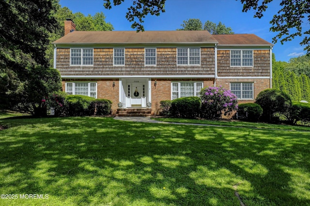 4 Briarcliff Ln, Holmdel, NJ 07733 - view of front of home featuring a front yard, a chimney, and brick siding