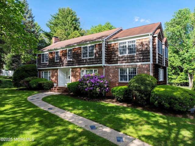 4 Briarcliff Ln, Holmdel, NJ 07733 - view of front of house featuring a chimney, a front lawn, and brick siding