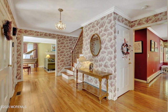 4 Briarcliff Ln, Holmdel, NJ 07733 - hall with baseboard heating, light wood-style flooring, stairway, a chandelier, and ornamental molding