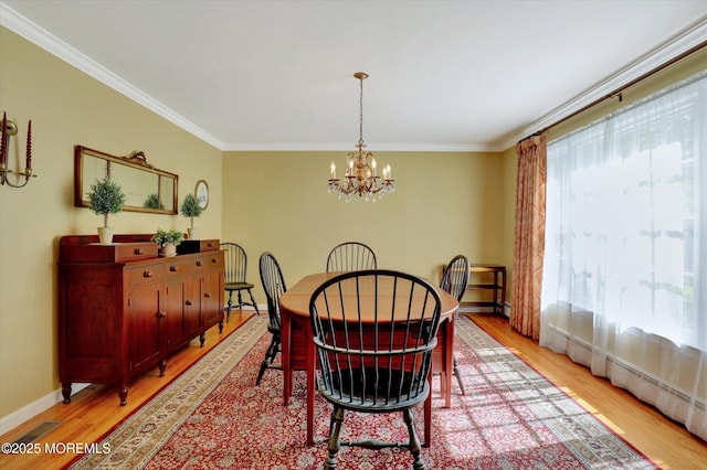 4 Briarcliff Ln, Holmdel, NJ 07733 - dining space with light wood-style floors, a chandelier, ornamental molding, and baseboards