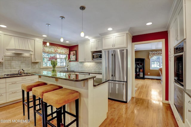 4 Briarcliff Ln, Holmdel, NJ 07733 - kitchen with appliances with stainless steel finishes, healthy amount of natural light, a kitchen breakfast bar, a center island, and recessed lighting
