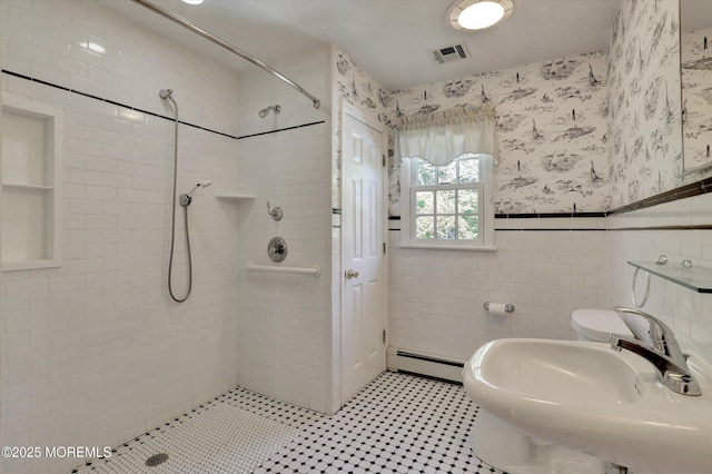4 Briarcliff Ln, Holmdel, NJ 07733 - bathroom featuring a baseboard radiator, a tile shower, wainscoting, wallpapered walls, and tile walls