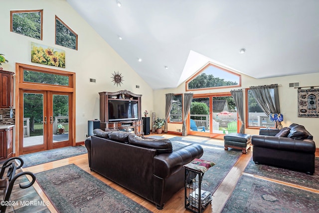 living area with french doors, high vaulted ceiling, visible vents, recessed lighting, and light wood-style floors