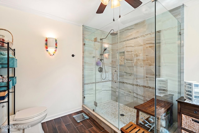 full bath with wood finished floors, ornamental molding, a stall shower, ceiling fan, and baseboards