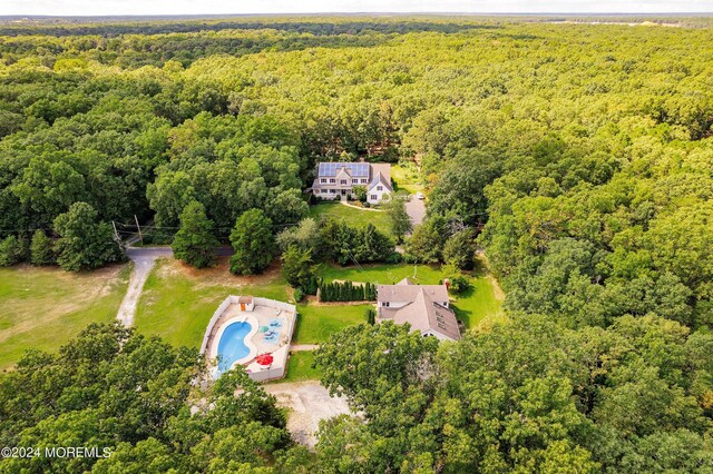 birds eye view of property with a wooded view