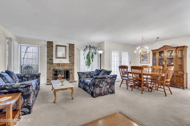 452B Heather Ct, Manchester, NJ 08759 - carpeted living area featuring plenty of natural light, a brick fireplace, and an inviting chandelier