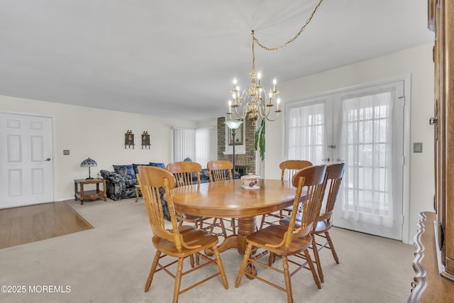 452B Heather Ct, Manchester, NJ 08759 - dining area with french doors, a chandelier, and a healthy amount of sunlight