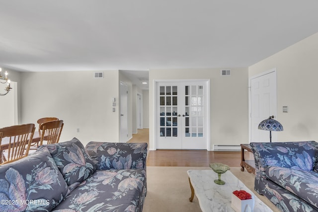 452B Heather Ct, Manchester, NJ 08759 - living room with a notable chandelier, visible vents, french doors, and a baseboard radiator