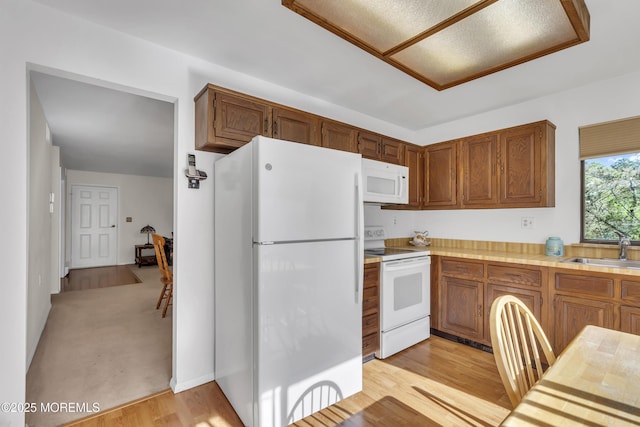 452B Heather Ct, Manchester, NJ 08759 - kitchen with a sink, light wood finished floors, white appliances, light countertops, and brown cabinetry