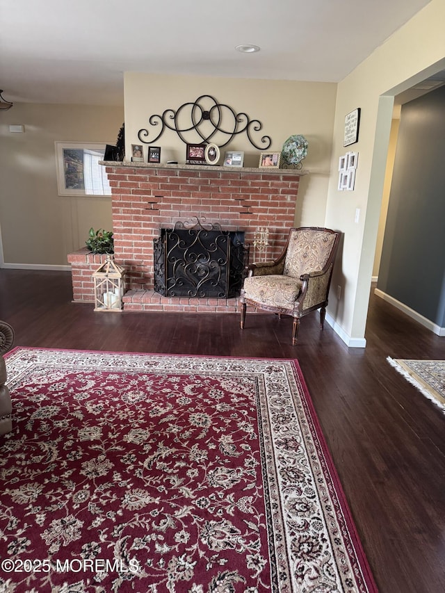 living area with recessed lighting, baseboards, wood finished floors, and a fireplace