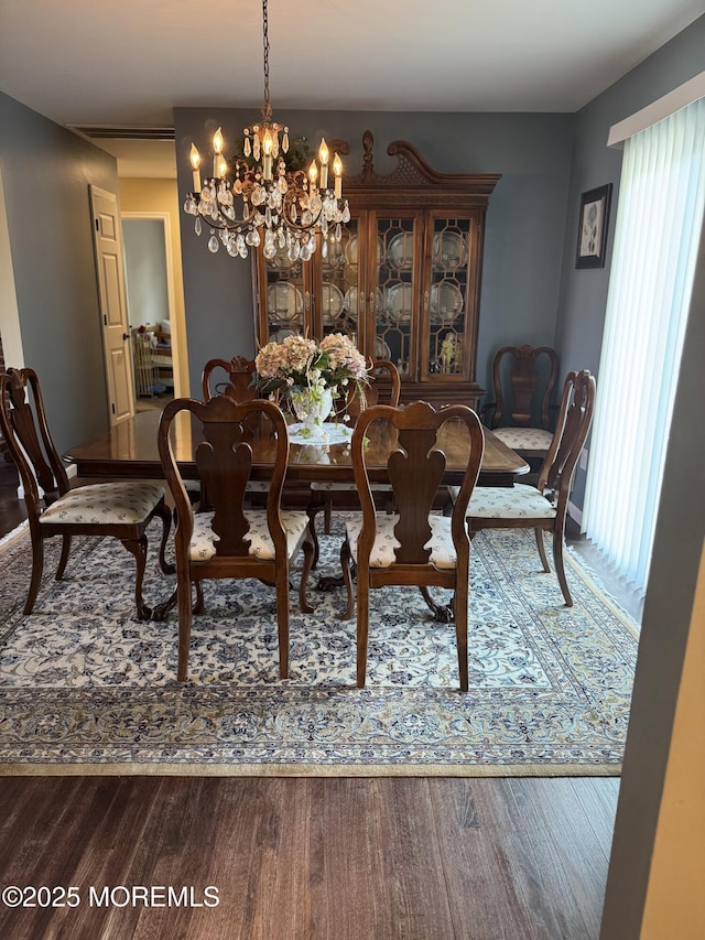 dining area featuring plenty of natural light, wood finished floors, and a chandelier