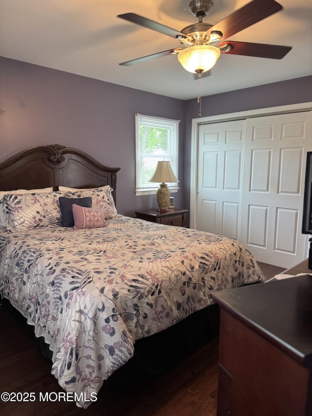 bedroom with a closet, a ceiling fan, and dark wood-style flooring