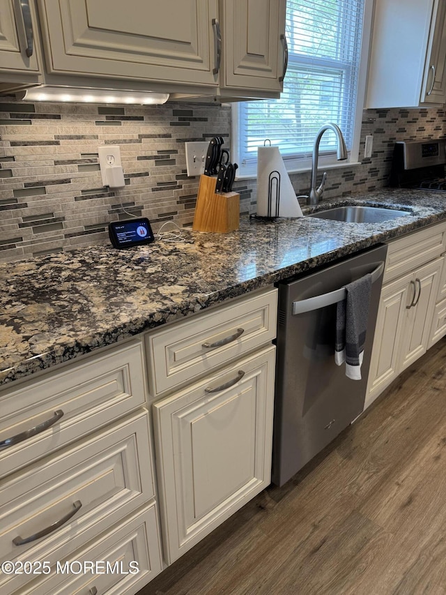 kitchen featuring backsplash, stainless steel appliances, dark wood-style floors, and a sink