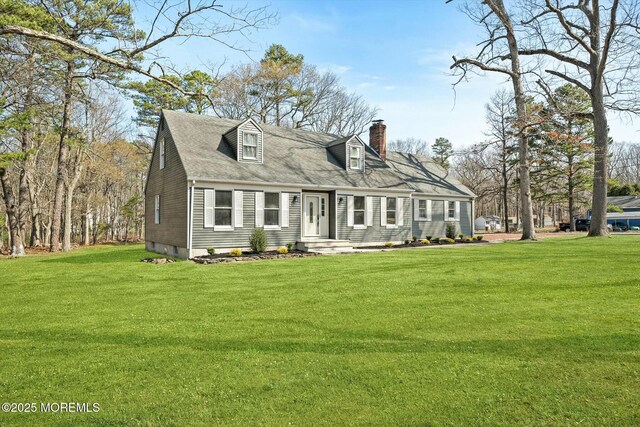 view of front facade featuring a chimney and a front lawn