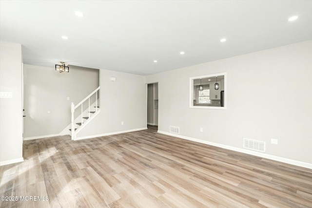 spare room featuring recessed lighting, visible vents, and stairs