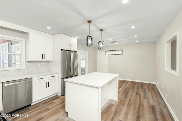 kitchen with appliances with stainless steel finishes, light wood-style flooring, light countertops, and recessed lighting