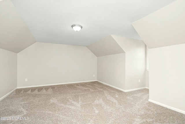 bonus room with vaulted ceiling, carpet flooring, and baseboards