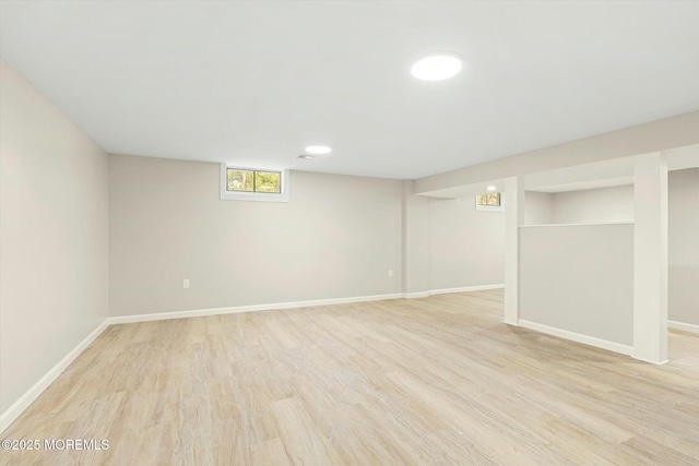 basement featuring baseboards and wood finished floors