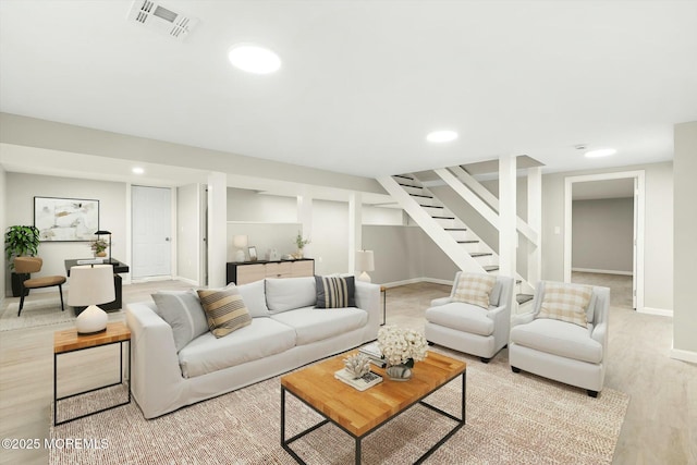 living room with visible vents, stairs, light wood finished floors, and recessed lighting