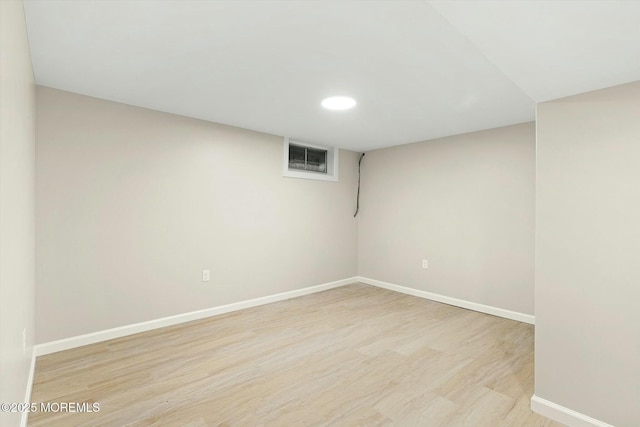 finished basement featuring recessed lighting, visible vents, light wood finished floors, and baseboards