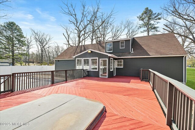 deck featuring a sunroom and fence