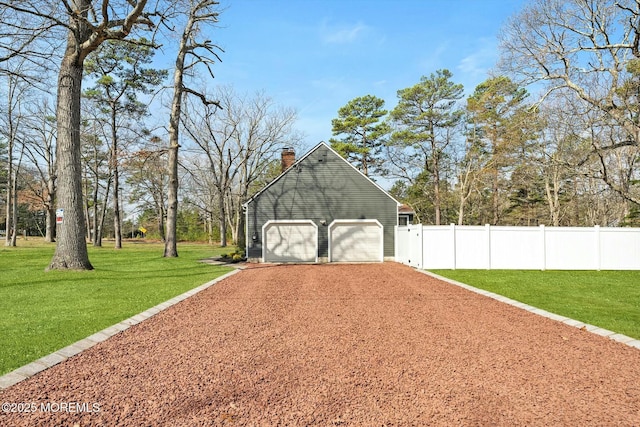 exterior space with fence and dirt driveway