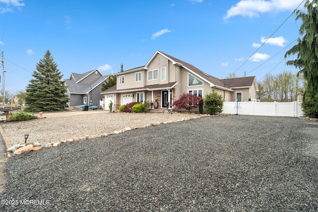 traditional home featuring fence and driveway