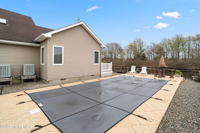 view of pool featuring cooling unit, a fenced in pool, and a patio area