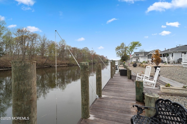 view of dock featuring a water view and a residential view