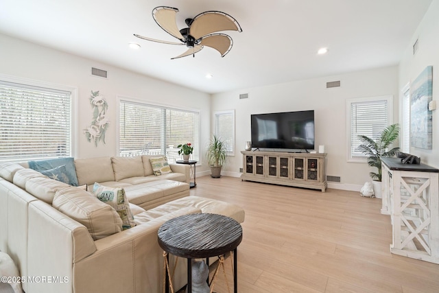 living room with visible vents, ceiling fan, and a healthy amount of sunlight