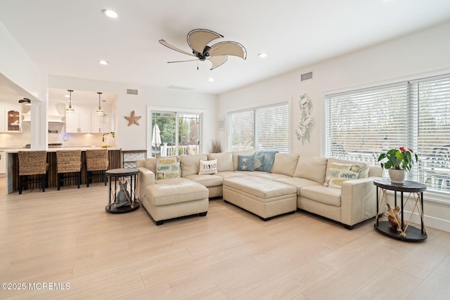 living area featuring recessed lighting, a ceiling fan, visible vents, and light wood-type flooring