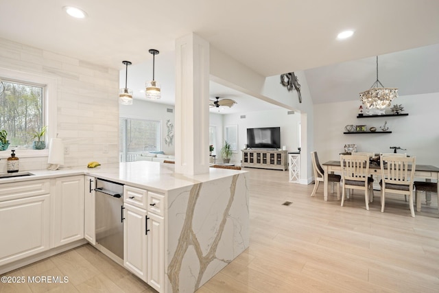 kitchen with light stone countertops, open floor plan, recessed lighting, and hanging light fixtures
