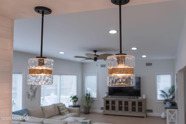 living room featuring recessed lighting, a ceiling fan, and a wealth of natural light