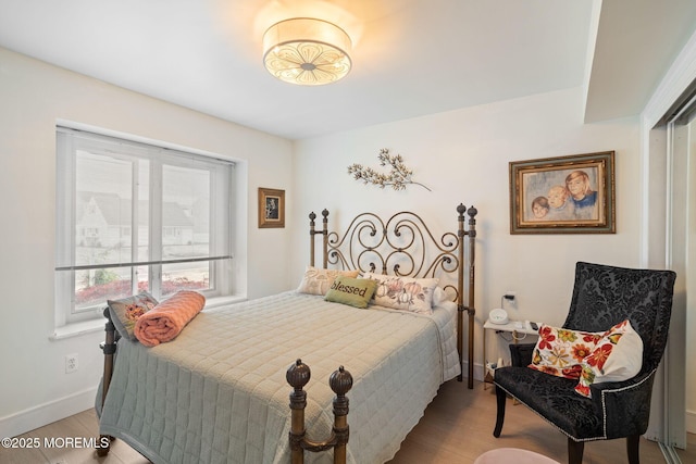 bedroom featuring baseboards and light wood-type flooring