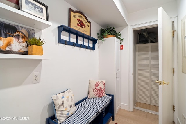 mudroom featuring baseboards and wood finished floors
