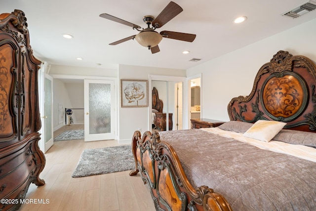 bedroom with recessed lighting, visible vents, and wood finished floors
