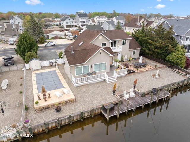 birds eye view of property featuring a water view and a residential view